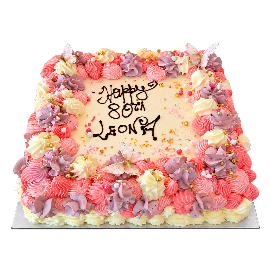 Square celebration cake piped with pink and lilac buttercream