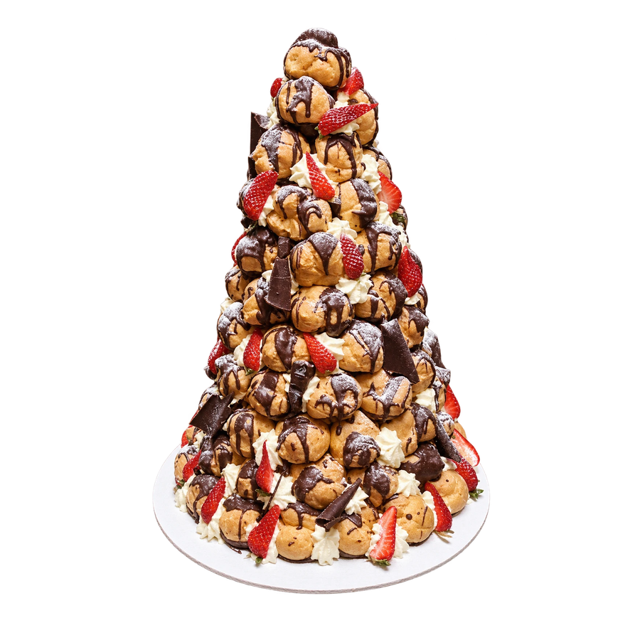 Profiterole tower with chocolate, cream and strawberries